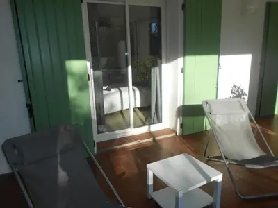 a room with two chairs and a table and a mirror at Appartement Aloa in Carcassonne