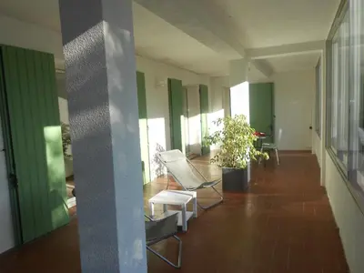 a hallway with chairs and a plant in a building at Appartement Aloa in Carcassonne