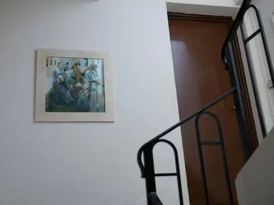 a painting on a wall next to a stairway at Appartement Aloa in Carcassonne