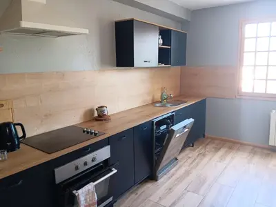 a kitchen with blue cabinets and a sink at El terret in Sigean