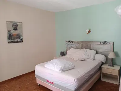 a bed with white sheets and pillows in a room at El terret in Sigean