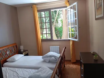 a bedroom with two beds and a window at El terret in Sigean