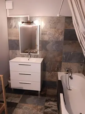 a bathroom with a sink and a tub and a mirror at El terret in Sigean