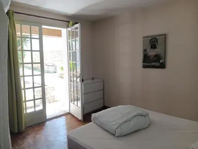 a bedroom with a bed and an open door at El terret in Sigean