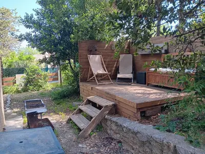two chairs sitting on a wooden deck in a backyard at El terret in Sigean