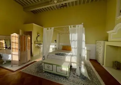a bedroom with a bed with a canopy at Les Cazettes in Damiatte