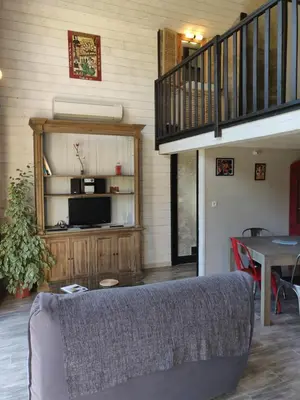a living room with a couch and a table at Gites Arnoult in Damiatte