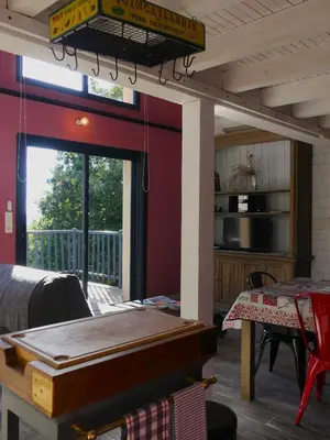 a living room with a pool table and a balcony at Gites Arnoult in Damiatte