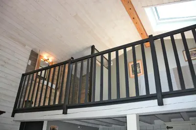 a balcony with black railing in a house at Gites Arnoult in Damiatte