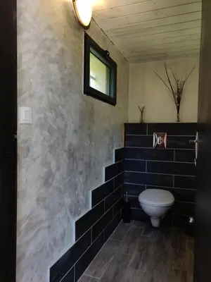 a bathroom with a staircase with a toilet in it at Gites Arnoult in Damiatte