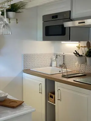 a white kitchen with a sink and a microwave at Pavillon confort pour 2 personnes GRUISSAN in Gruissan