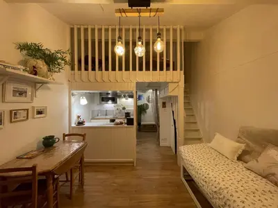 a living room with a table and a dining room at Pavillon confort pour 2 personnes GRUISSAN in Gruissan