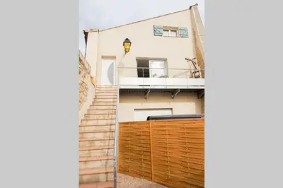 a view of a house with a wooden fence at La Porte du Midi in Mailhac