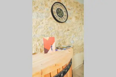 a stone wall with a clock on top of a counter at La Porte du Midi in Mailhac