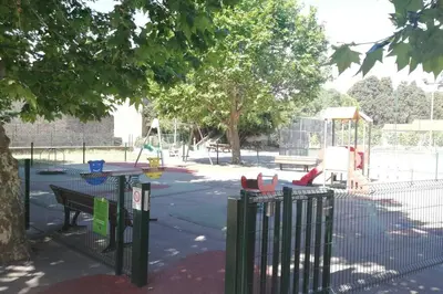 a park with a playground with a table and a play area at La Porte du Midi in Mailhac