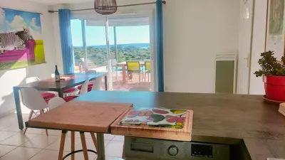 a kitchen with a table and a dining room at Maison avec vue sur la mer et avec piscine à Fitou in Fitou