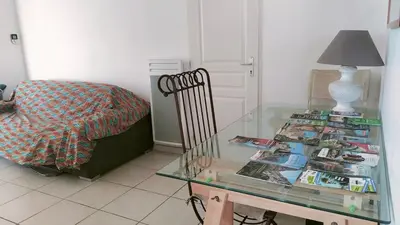 a living room with a glass table and a chair at Maison avec vue sur la mer et avec piscine à Fitou in Fitou
