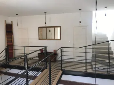 a room with stairs and a mirror on the wall at L Ostalada in Roquefort-des-Corbières
