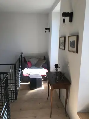 a room with a bed and a table in a room at L Ostalada in Roquefort-des-Corbières