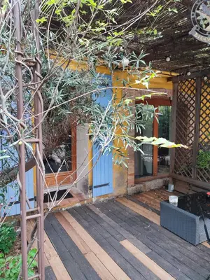 a porch of a house with a wooden deck at Domaine Les Cascades in Ribaute