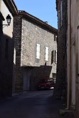 a car parked in front of a stone building at Domaine Les Cascades in Ribaute