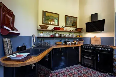 a kitchen with a sink and a counter top at Maison d'Hôtes de La Rivière in Pexiora