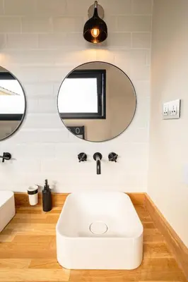 a bathroom with a white tub and a mirror at L'entre deux-suite romantique - jacuzzi privatif - clim réversible - wifi in Le Somail