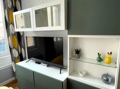a living room with a tv on a cabinet at Pause Cathare in Chalabre