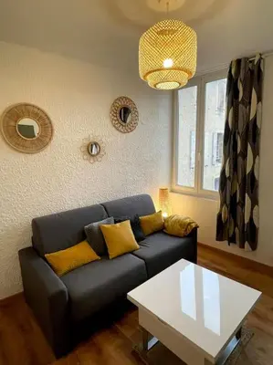 a living room with a couch and a table at Pause Cathare in Chalabre