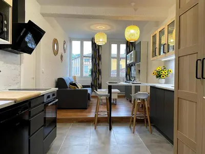 a kitchen and living room with a table and chairs at Pause Cathare in Chalabre