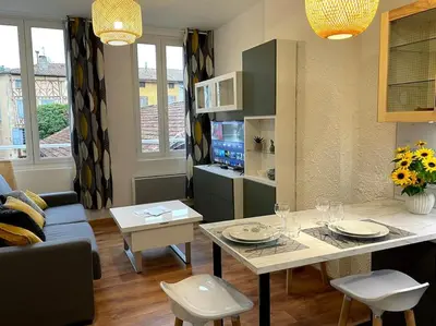 a kitchen and living room with a table and chairs at Pause Cathare in Chalabre