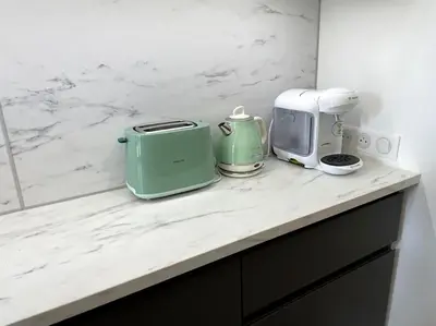 a kitchen counter with appliances on a white counter top at Pause Cathare in Chalabre