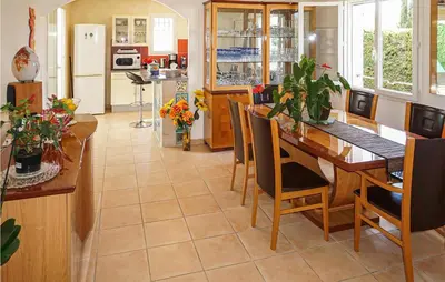 a kitchen and dining room with a table and chairs at Stunning Home In Puisserguier in Puisserguier