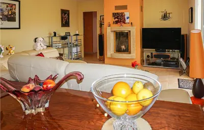 a living room with a bowl of fruit on a table at Stunning Home In Puisserguier in Puisserguier