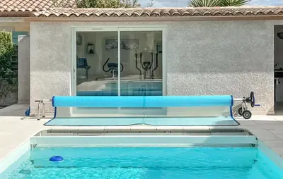 a swimming pool in front of a house at Stunning Home In Puisserguier in Puisserguier