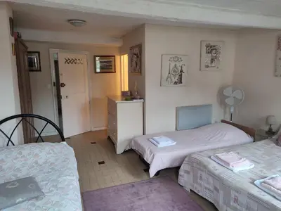 a bedroom with two twin beds and a dresser at Chateau View Chambres d'hôtes in Quillan