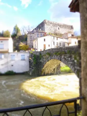 a stone bridge over a river in a town at Chateau View Chambres d'hôtes in Quillan