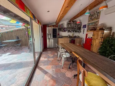 a kitchen with a long wooden table and chairs at Origines in Tautavel