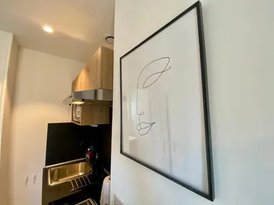 a picture hanging on a wall in a kitchen at Studios Sauzède - Carcassonne centre-ville in Carcassonne
