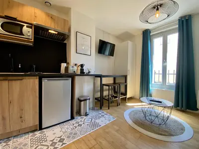 a kitchen with a table and a counter top at Studios Sauzède - Carcassonne centre-ville in Carcassonne