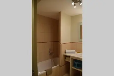 a bathroom with a bath tub and a sink at Gîte - Holiday Home Vent Tramontane in Limoux