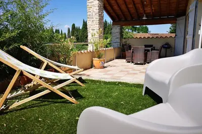 a couple of chairs and a table in a yard at Gîte - Holiday Home Vent Tramontane in Limoux