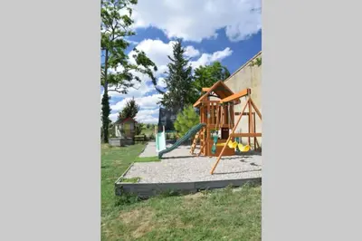 a playground with a slide and a swing set at Gîte - Holiday Home Vent Tramontane in Limoux