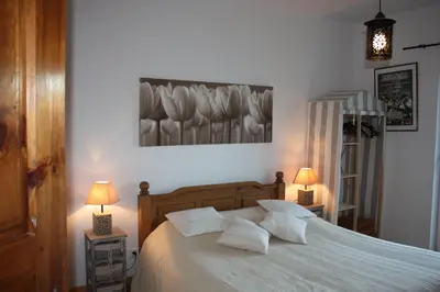 a bedroom with a bed with white sheets and pillows at Domaine de 
