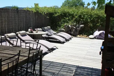 a row of chairs and tables on a wooden deck at Domaine de 
