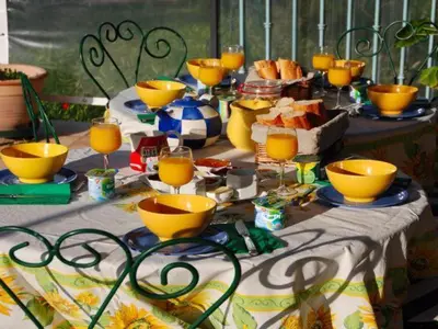 a table topped with yellow cups and plates of food at Domaine de 