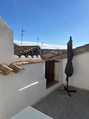 a closed umbrella sitting on the ledge of a building at Loft Toit Terrasse - Confort & Nature à Sigean in Sigean