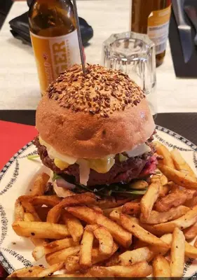 a hamburger and french fries on a plate at Loft Toit Terrasse - Confort & Nature à Sigean in Sigean