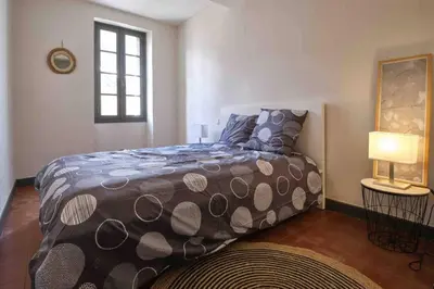 a bedroom with a bed and a window at CENTRE VILLE Appartement 75m2, avec 3 chambres in Carcassonne