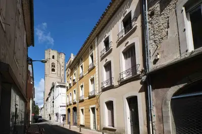 a city street with buildings and a clock tower at CENTRE VILLE Appartement 75m2, avec 3 chambres in Carcassonne